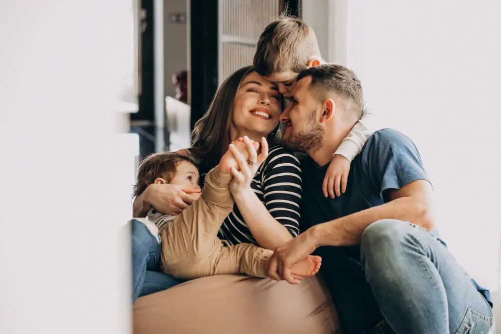 young-family-with-their-sons-home-having-fun (1) Family Strong