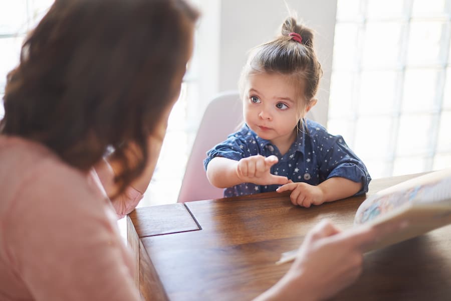 Cute Girl With Mom Reading Book (1)